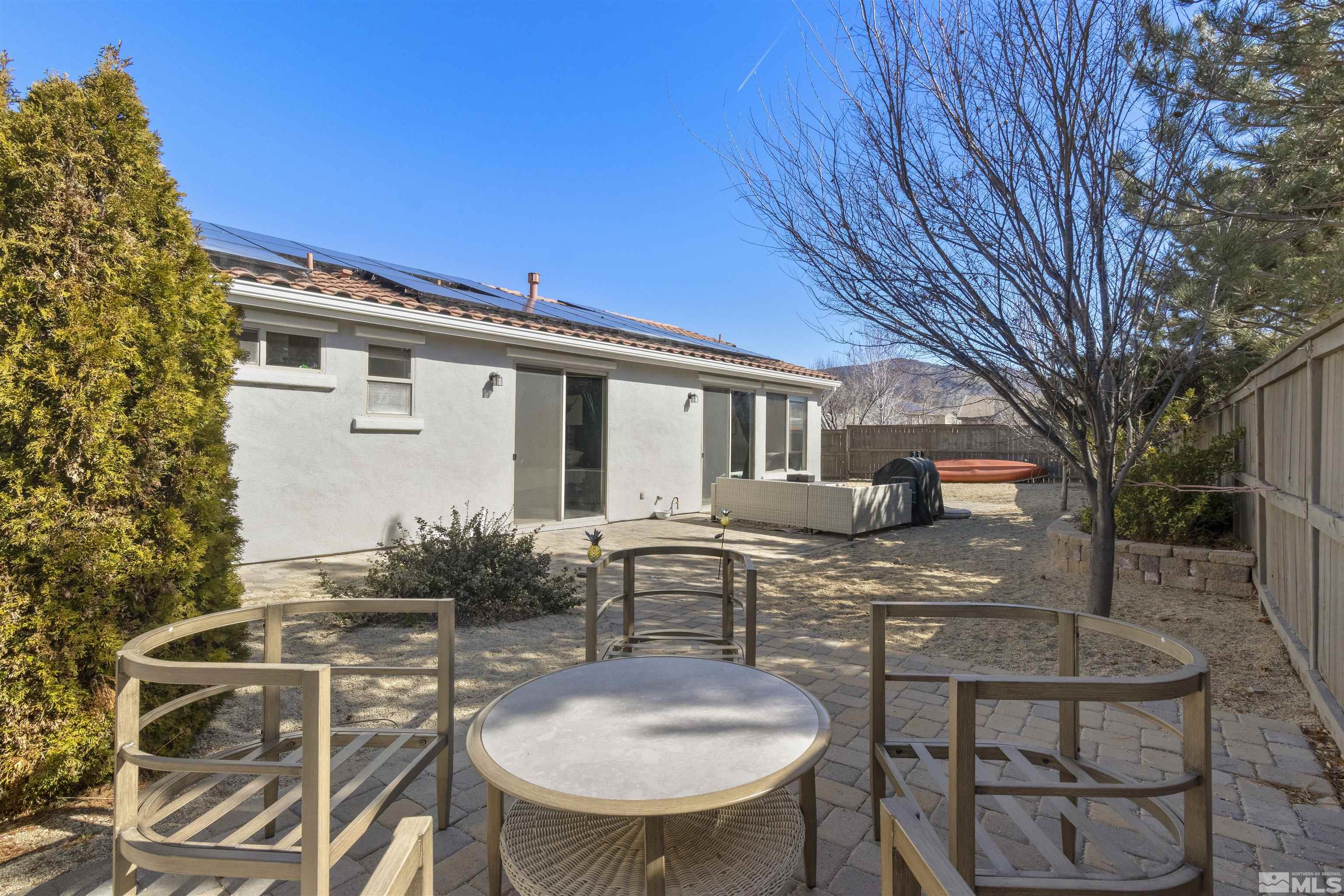 490 Haleb Court Reno, NV 89521 - Photo 26 of 26 a view of a patio with table and chairs with wooden fence and plants