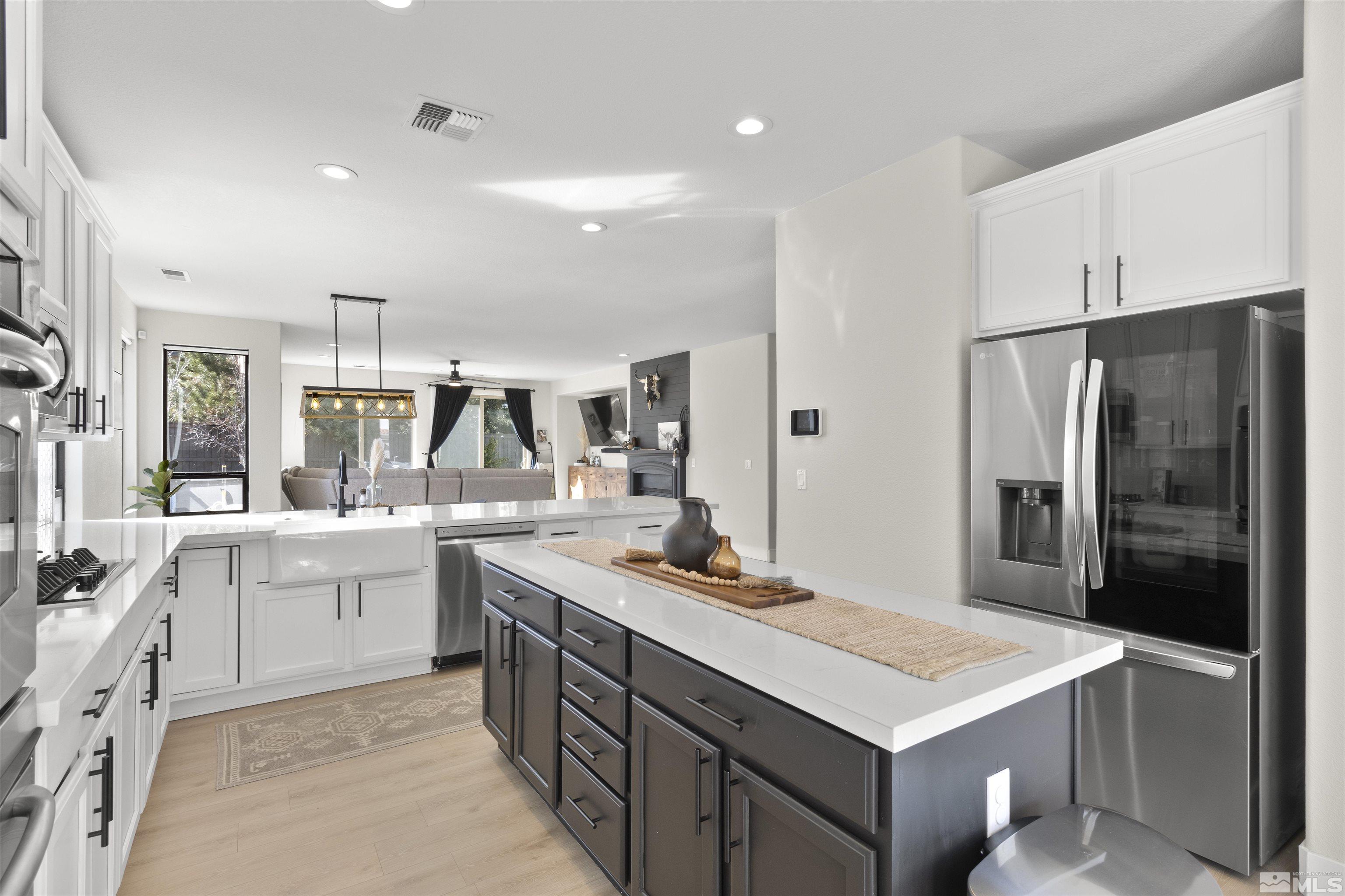 490 Haleb Court Reno, NV 89521 - Photo 5 of 26 a kitchen with stainless steel appliances a sink stove and refrigerator