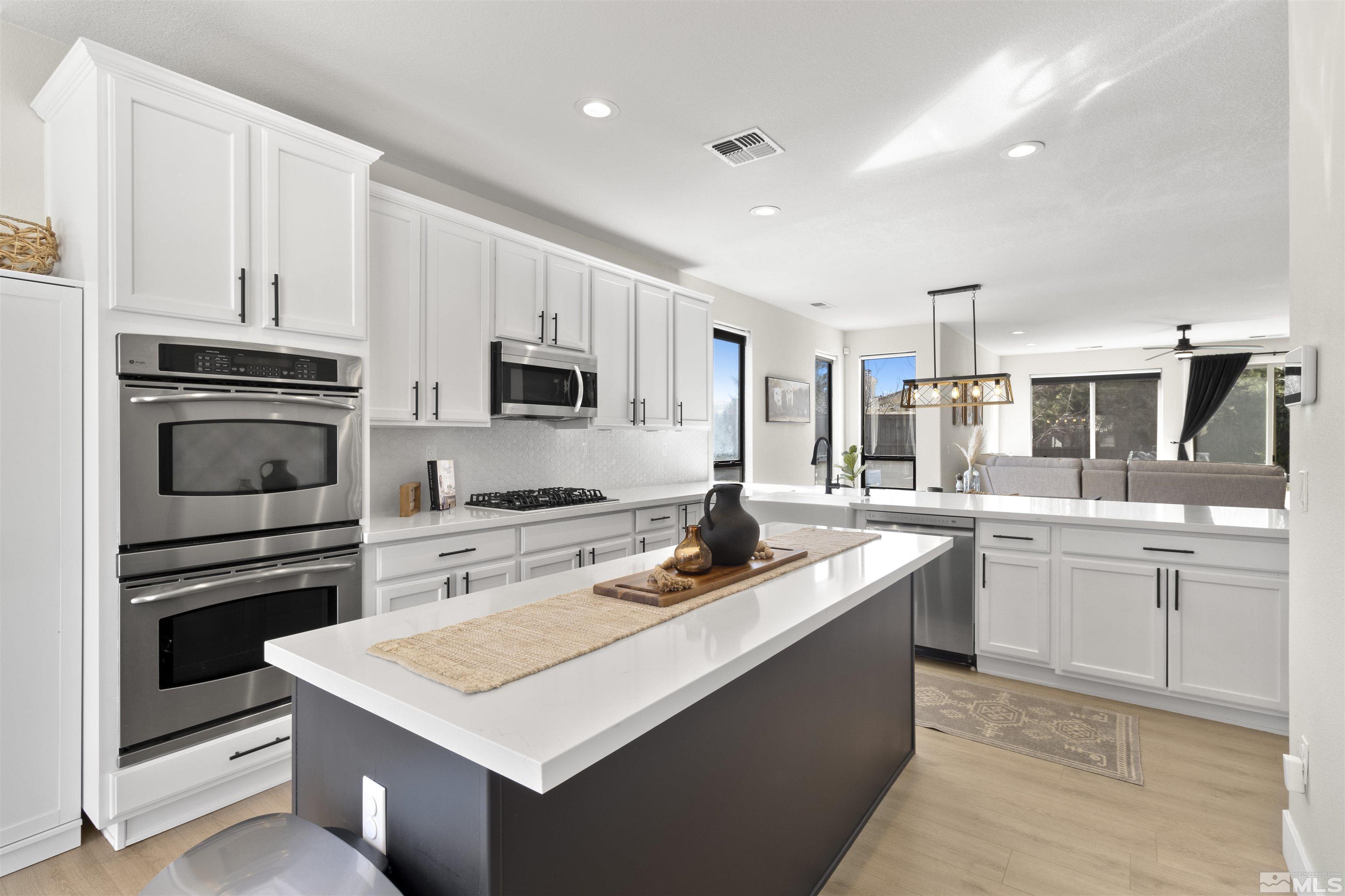 490 Haleb Court Reno, NV 89521 - Photo 6 of 26 a kitchen with cabinets appliances a sink and a counter top space