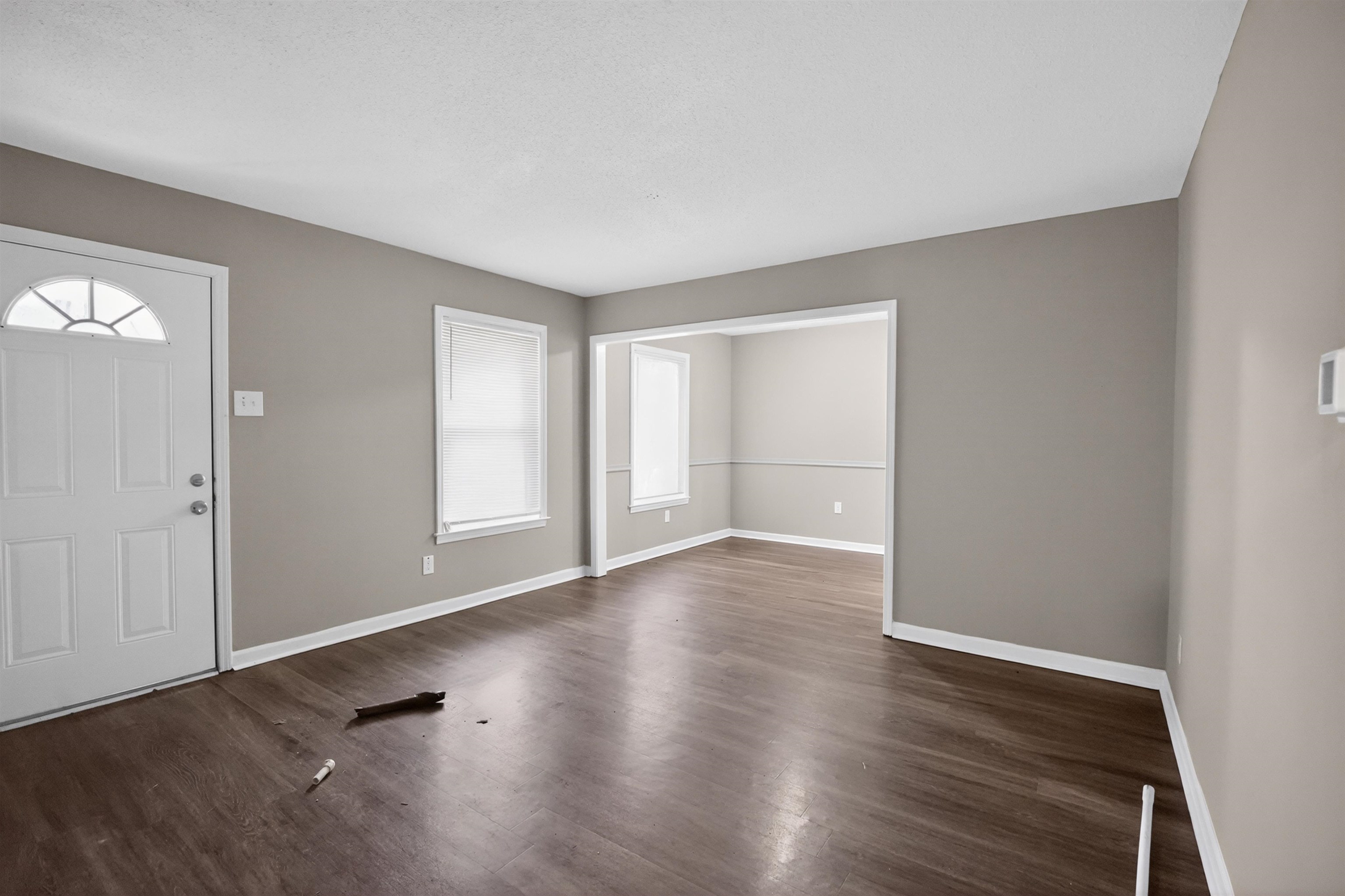 3152 Mackham Avenue Memphis, TN 38118 - Photo 6 of 16 Entry area featuring a white paneled door with an arched transom, wood-finish flooring, and neutral wall tones