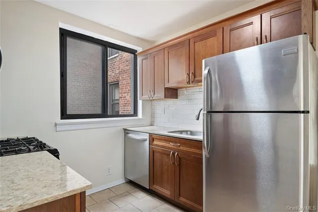 a white refrigerator freezer sitting inside of a kitchen