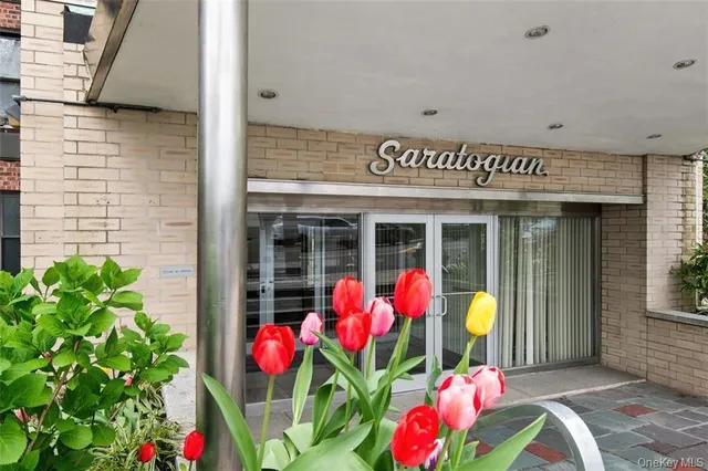 a front view of a multi story building with yard