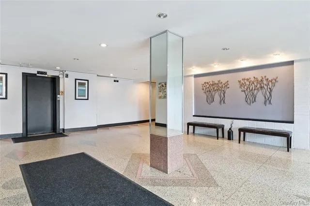 a view of a hallway with seating space