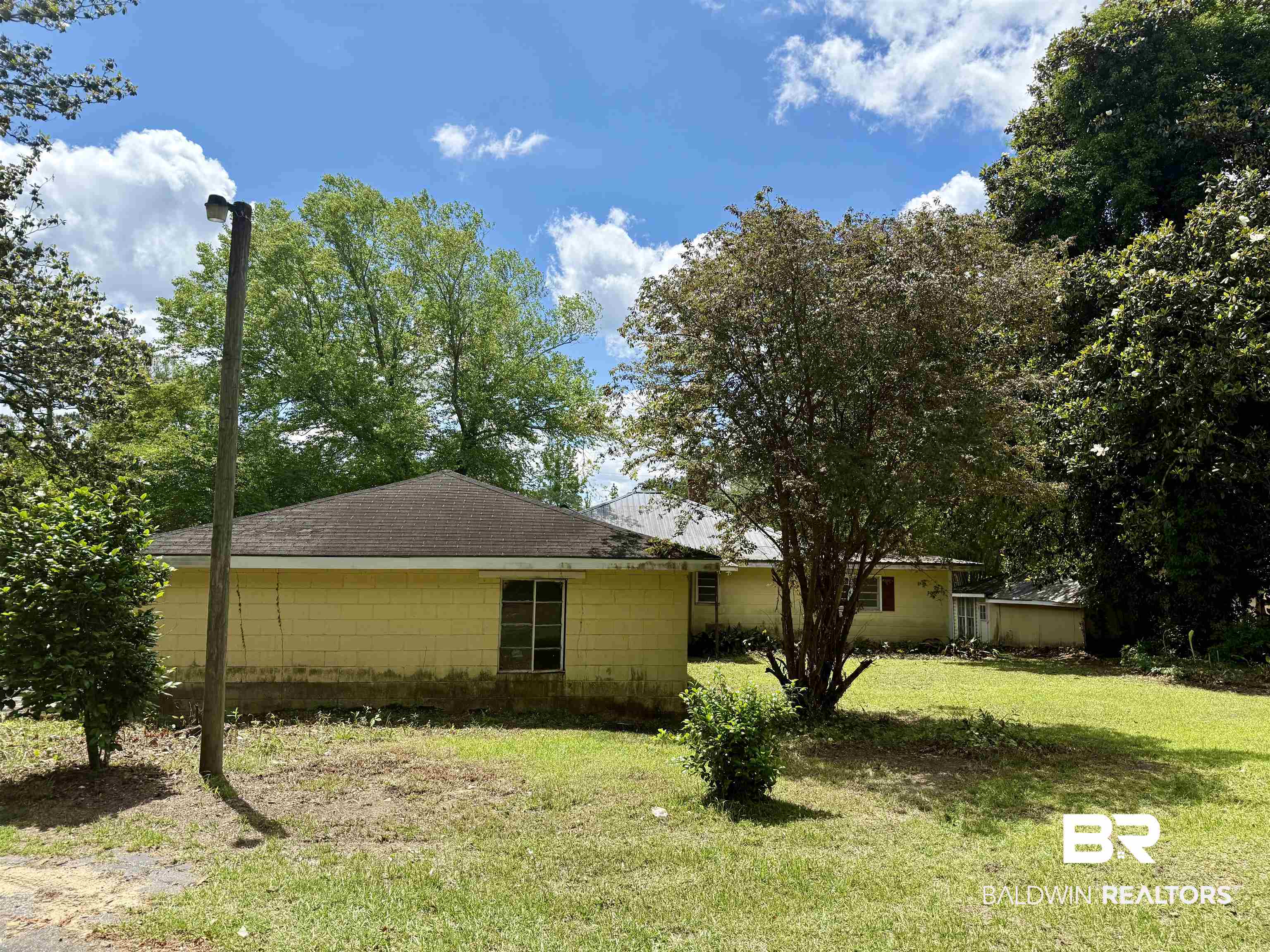 610 Alco Drive Brewton, AL 36426 - Photo 7 of 18 View of side of property featuring a lawn and a shingled roof