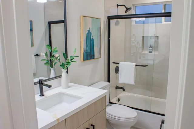 a bedroom with a bed and a mirror