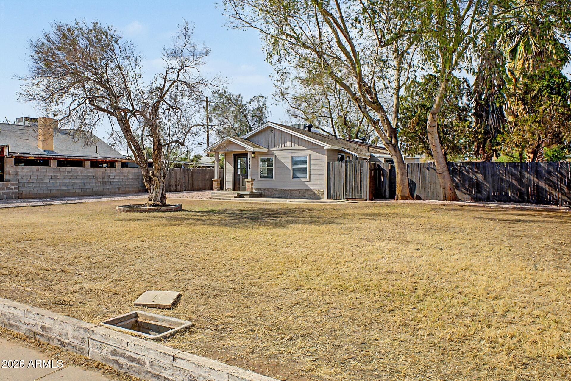 1914 East Monte Vista Road Phoenix, AZ 85006 - Photo 2 of 26 a house that has a tree in front of it