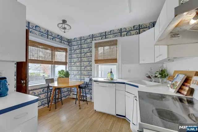 a kitchen with a table chairs stove and cabinets
