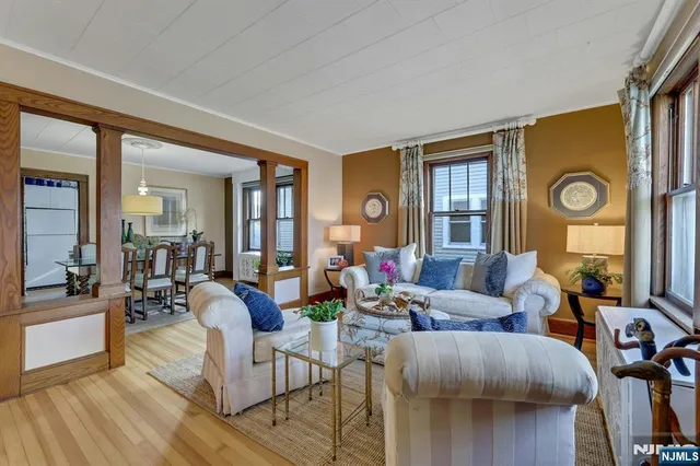 a living room with fireplace furniture and a wooden floor