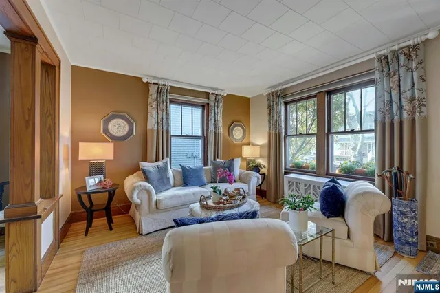 a living room with furniture and floor to ceiling windows