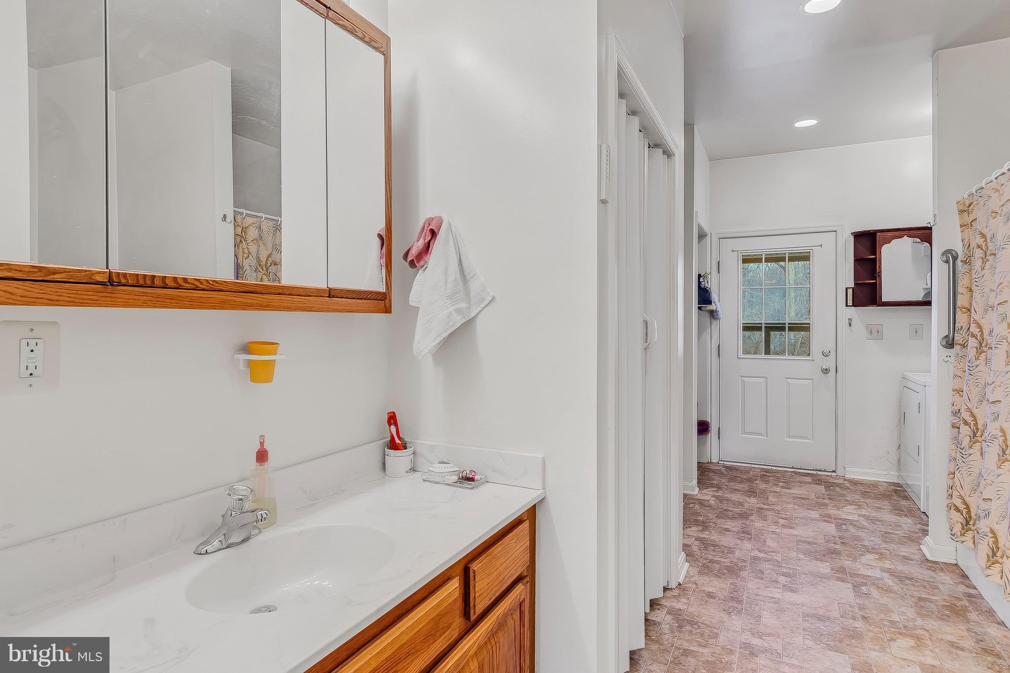 10120 Mackall Road St. Leonard, MD 20685 - Photo 22 of 29 a bathroom with a sink and a mirror