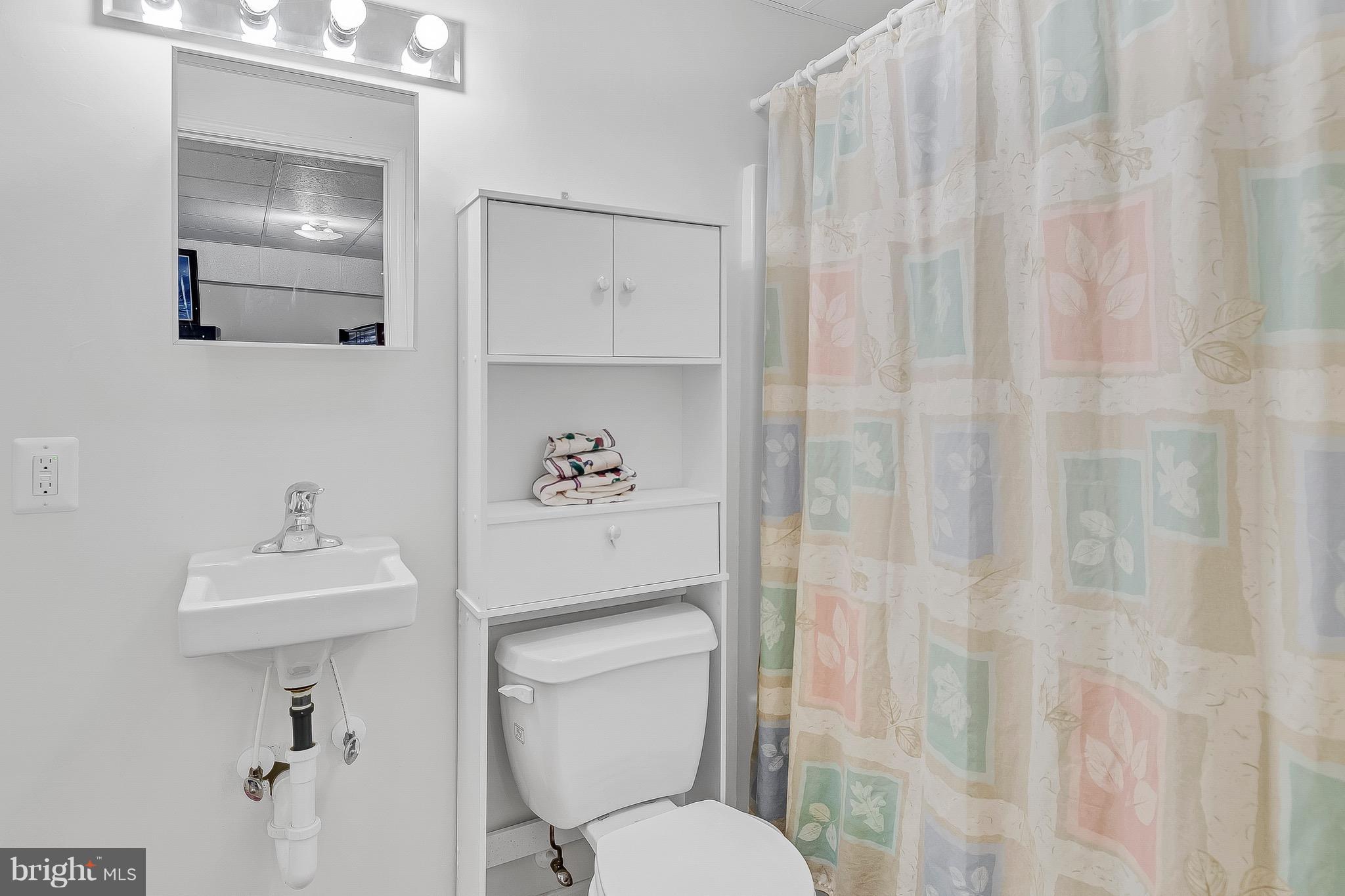 10120 Mackall Road St. Leonard, MD 20685 - Photo 26 of 29 a bathroom with a toilet sink and a mirror