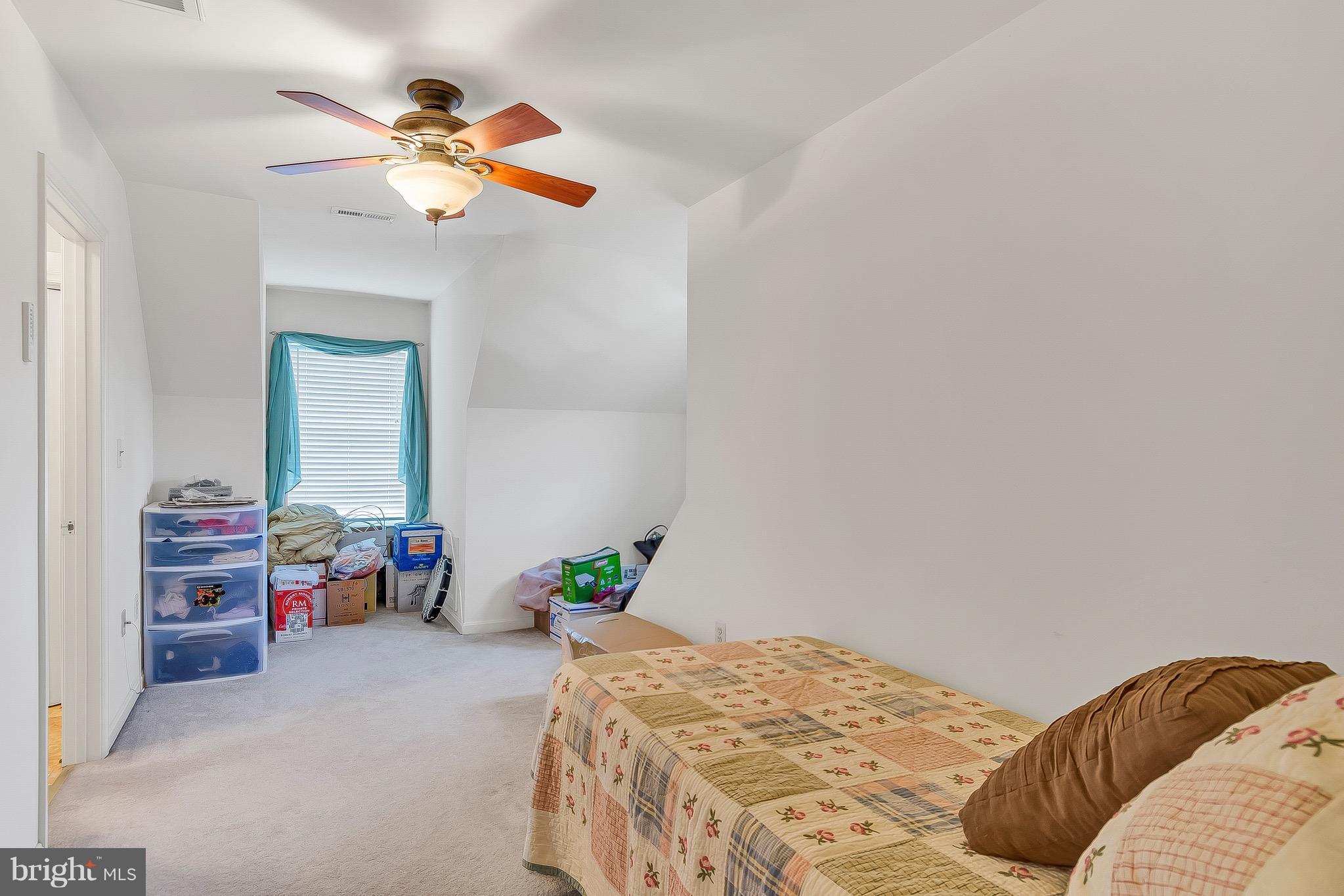 10120 Mackall Road St. Leonard, MD 20685 - Photo 28 of 29 a bedroom with a bed and a chandelier