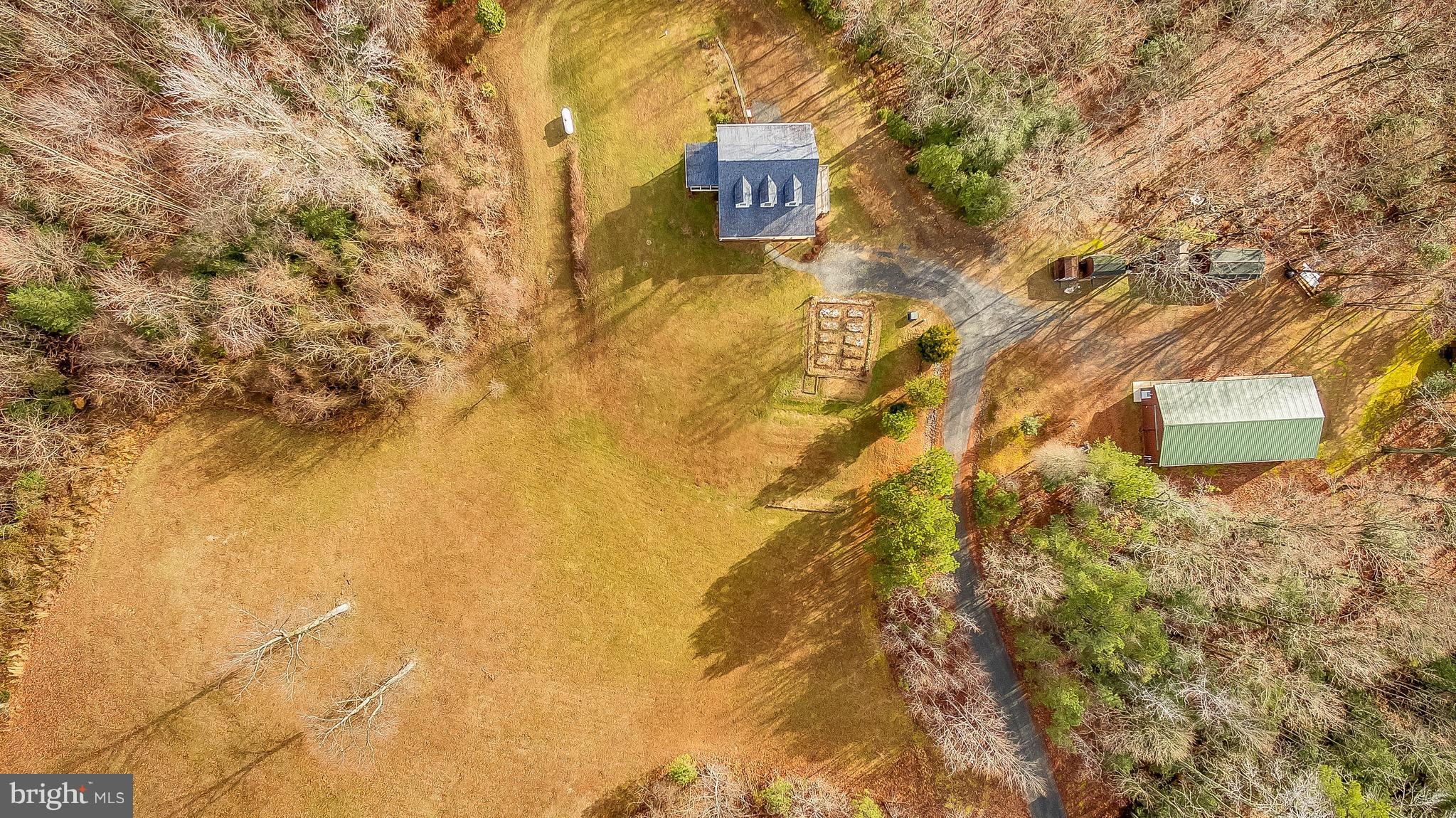 10120 Mackall Road St. Leonard, MD 20685 - Photo 6 of 29 a brick building with a yard