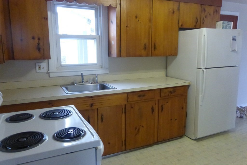 54 King Philip Road Worcester, MA 01606 - Photo 4 of 22 a kitchen with a refrigerator and a sink