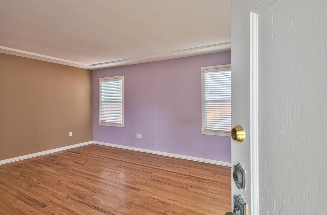 75 Mayfair Drive Salinas, CA 93905 - Photo 3 of 20 an empty room with wooden floor and windows