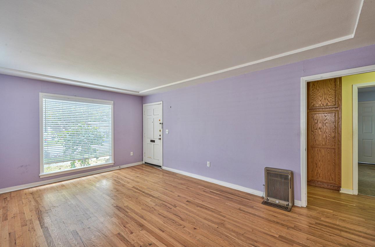 75 Mayfair Drive Salinas, CA 93905 - Photo 6 of 20 an empty room with wooden floor and windows
