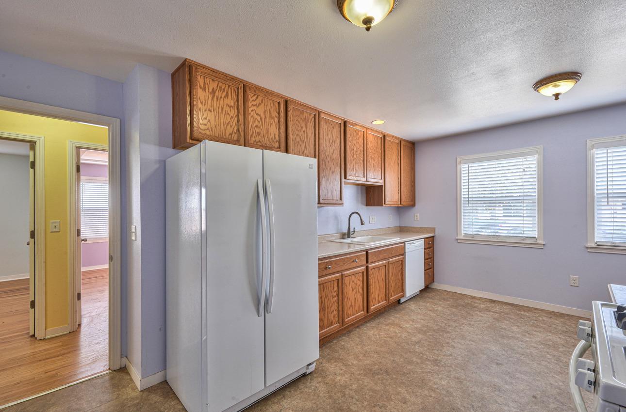 75 Mayfair Drive Salinas, CA 93905 - Photo 7 of 20 a kitchen with granite countertop a refrigerator and a sink