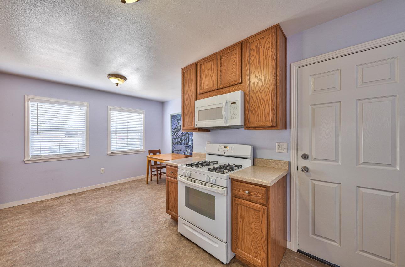 75 Mayfair Drive Salinas, CA 93905 - Photo 9 of 20 a kitchen with stainless steel appliances granite countertop a stove a sink and a microwave
