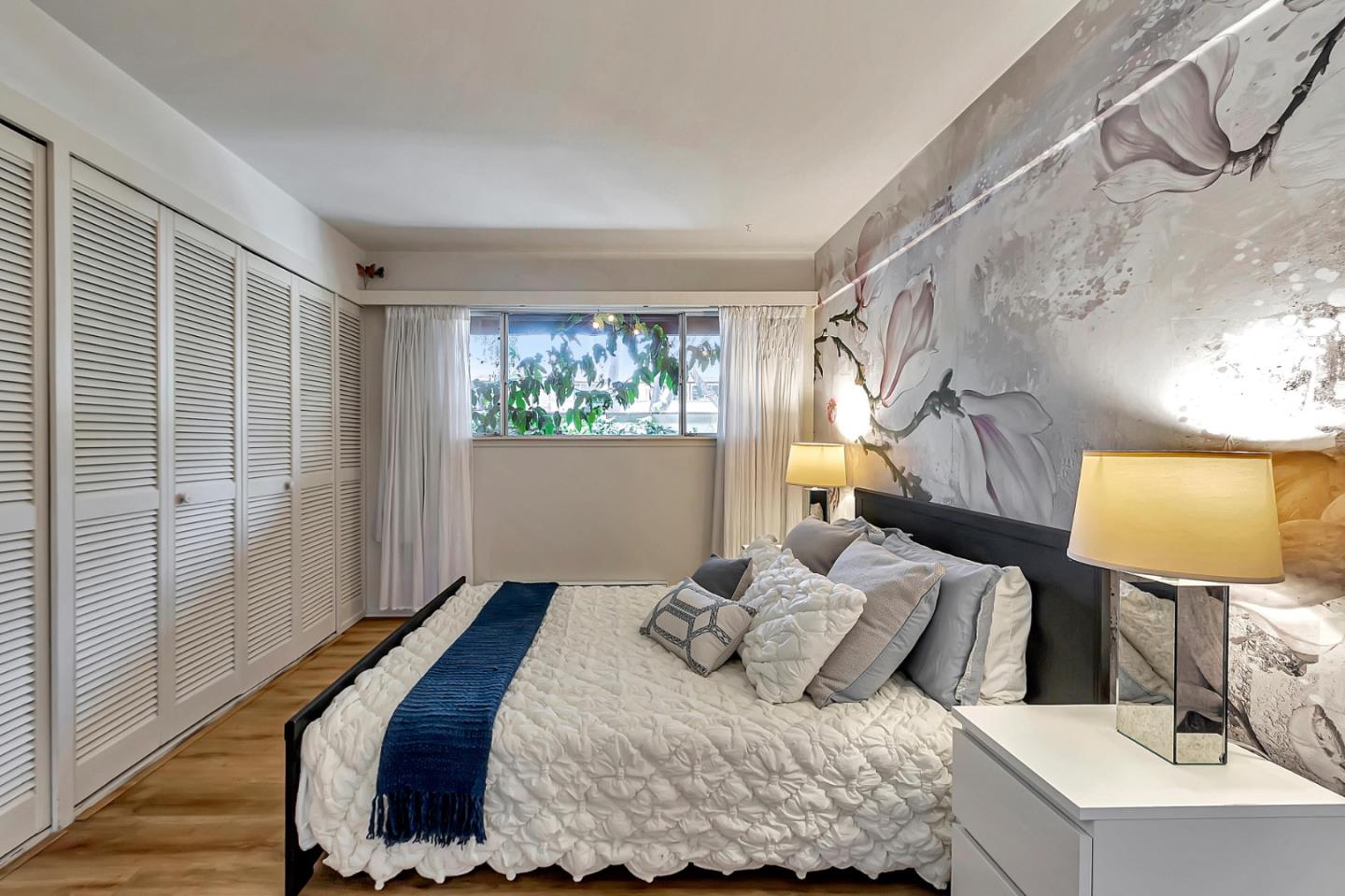 500 West Middlefield Road, Unit 71 Mountain View, CA 94043 - Photo 13 of 42 a bedroom with a bed and wooden floor