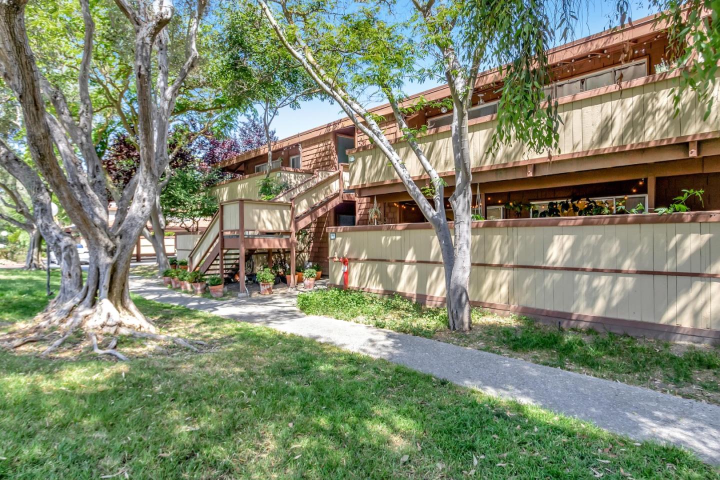 500 West Middlefield Road, Unit 71 Mountain View, CA 94043 - Photo 30 of 42 a view of a yard in front of a house with a large tree and plants
