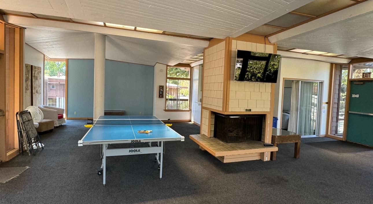 500 West Middlefield Road, Unit 71 Mountain View, CA 94043 - Photo 33 of 42 a living room with furniture a flat screen tv and a table