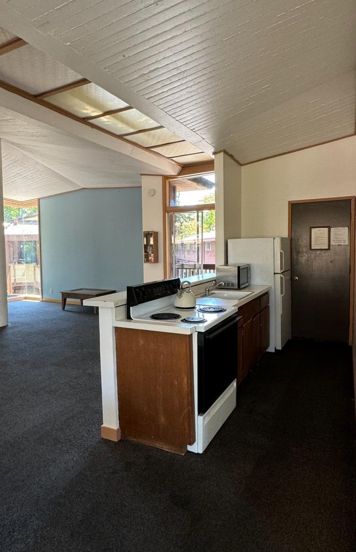 500 West Middlefield Road, Unit 71 Mountain View, CA 94043 - Photo 36 of 42 a kitchen with kitchen island granite countertop a sink cabinets and stainless steel appliances