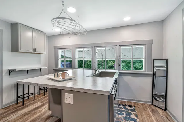 a dining room with furniture a rug and wooden floor