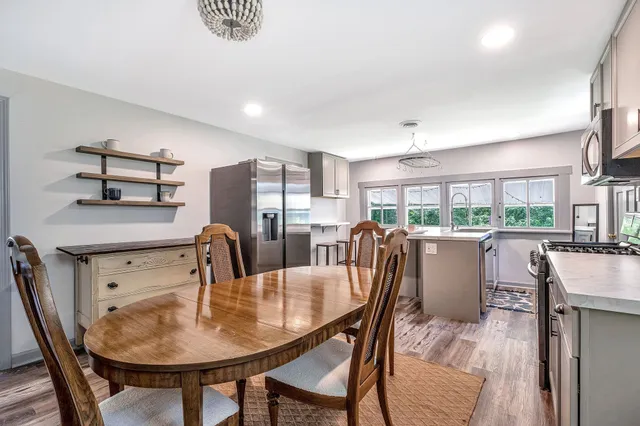a kitchen with a stove a microwave and dining table
