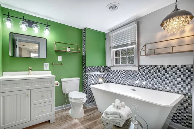 a bathroom with a sink a toilet and a mirror