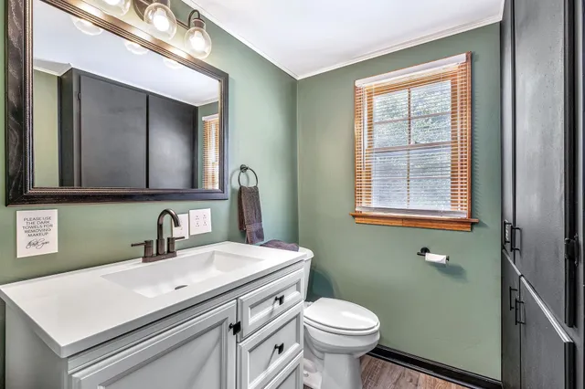 a bedroom with bed and wooden floor