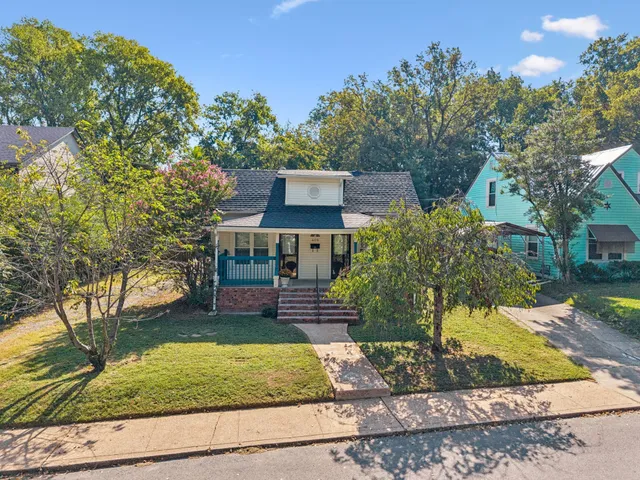 an aerial view of a house with a yard