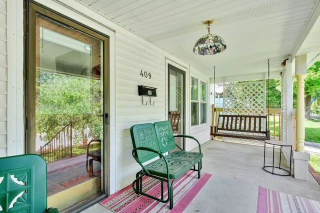 a living room with furniture a mirror and a fireplace