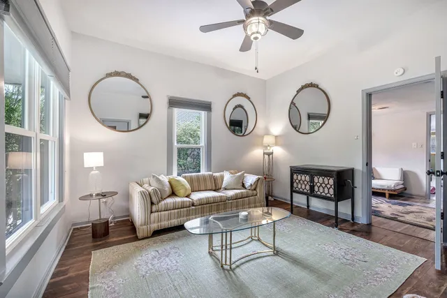 a living room with furniture a fireplace and a large window