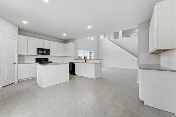 a kitchen with white cabinets and white appliances