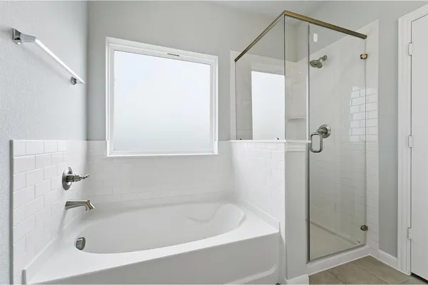 a white bath tub sitting next to a shower