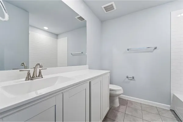 a bathroom with a sink a toilet and a mirror