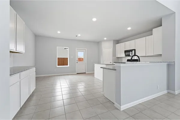 a kitchen with stainless steel appliances granite countertop a sink and cabinets