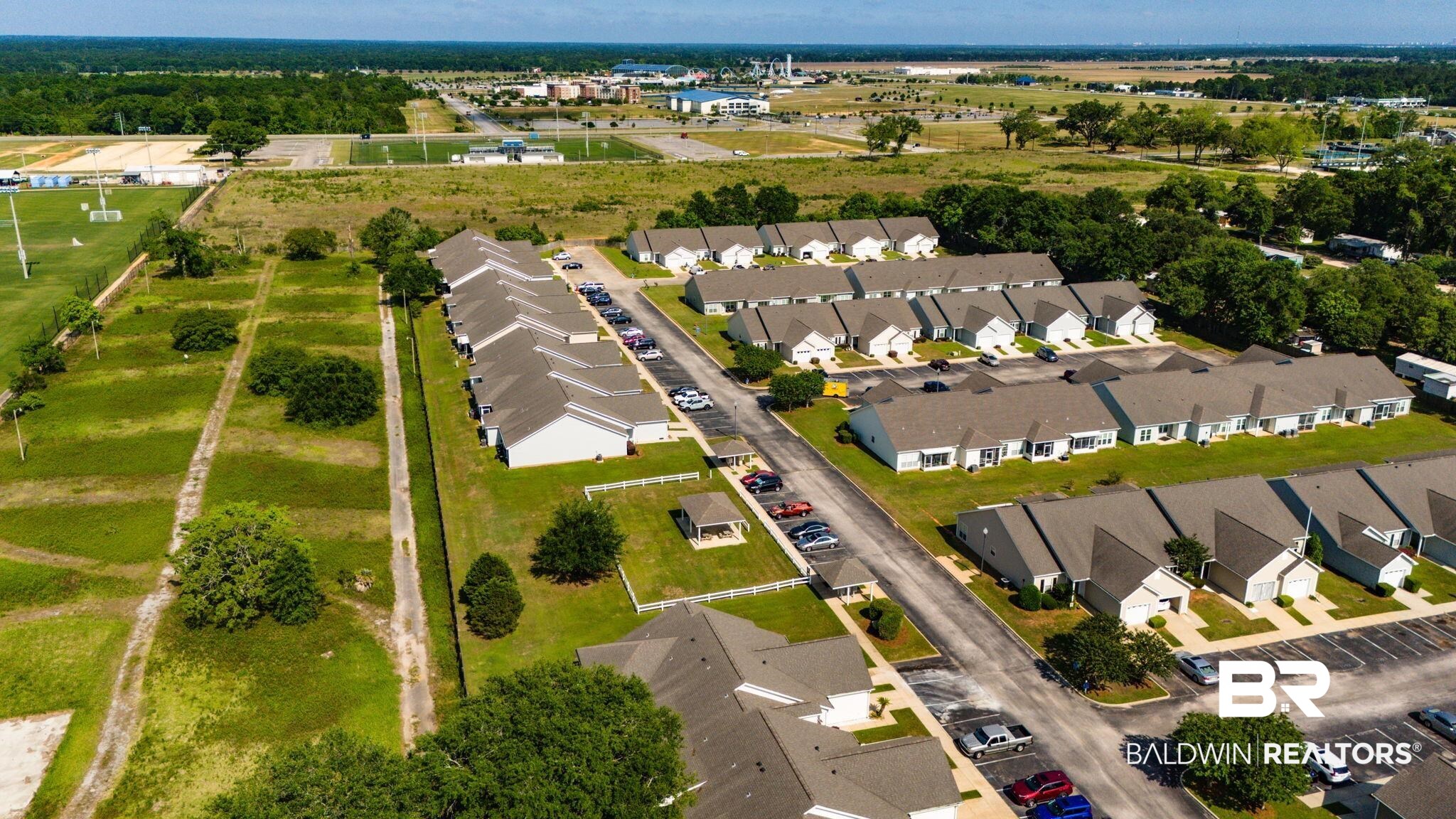 2651 South Juniper Street, Unit 705 Foley, AL 36535 - Photo 35 of 37 Aerial perspective showcasing a residential community with multiple single-story and two-story structures