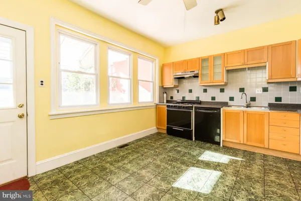 a kitchen with stainless steel appliances granite countertop a sink and a stove