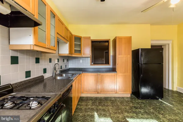 a kitchen with stainless steel appliances granite countertop a refrigerator and a stove