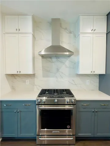 a stove top oven sitting inside of a kitchen