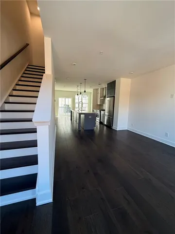 a view of entryway and hall with wooden floor