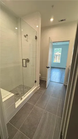 a bathroom with a glass shower door and a sink