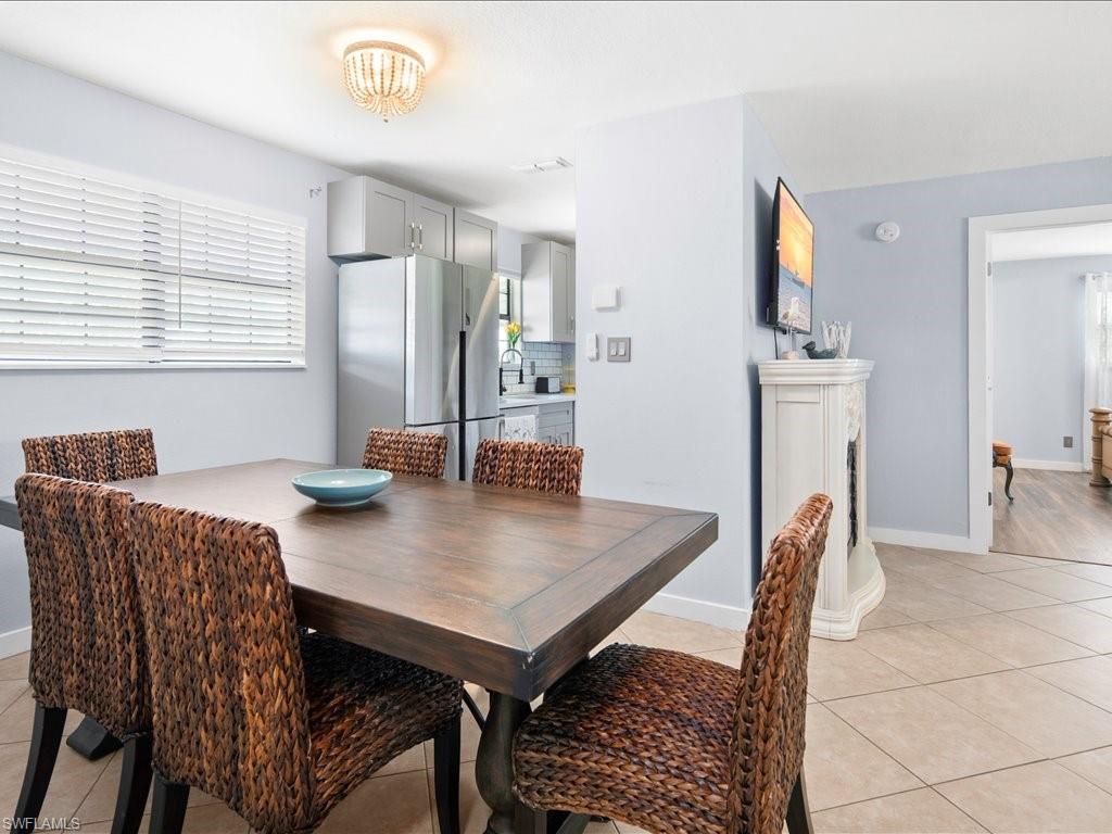 2469 Florida Avenue Naples, FL 34112 - Photo 12 of 31 Dining room featuring light tile patterned flooring and baseboards