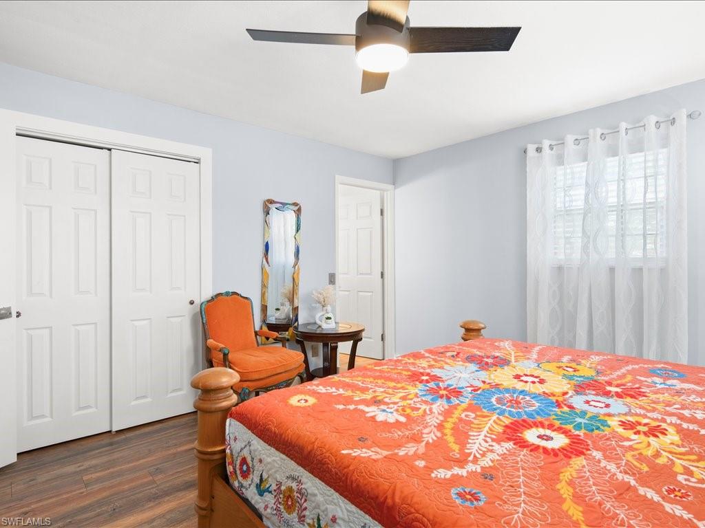2469 Florida Avenue Naples, FL 34112 - Photo 18 of 31 Bedroom featuring dark wood-type flooring, a ceiling fan, and a closet