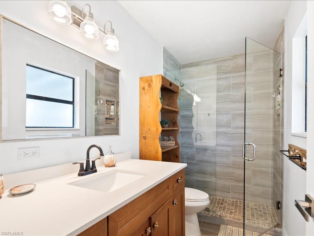 2469 Florida Avenue Naples, FL 34112 - Photo 20 of 31 Bathroom with plenty of natural light, vanity, and a shower stall