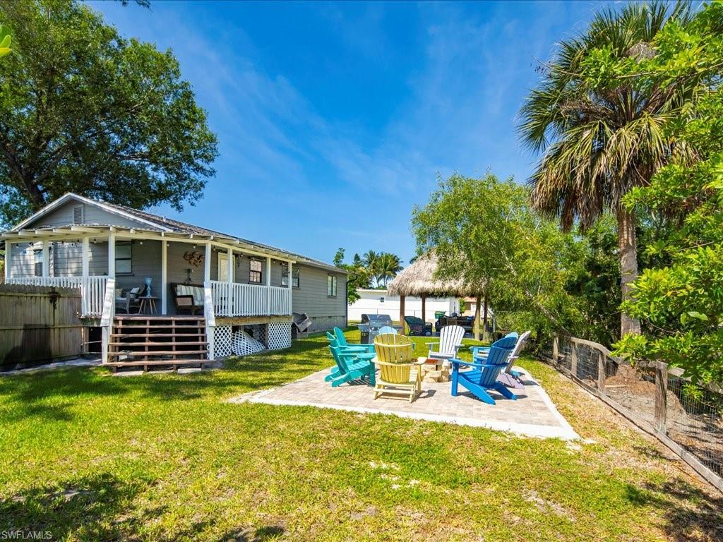 2469 Florida Avenue Naples, FL 34112 - Photo 2 of 31 Back of house featuring a fenced backyard, a patio, and stairs