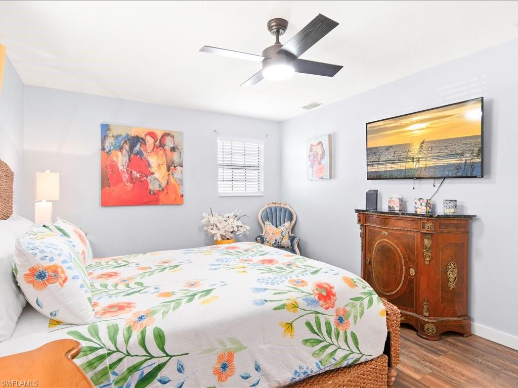 2469 Florida Avenue Naples, FL 34112 - Photo 22 of 31 Bedroom featuring wood finished floors and a ceiling fan