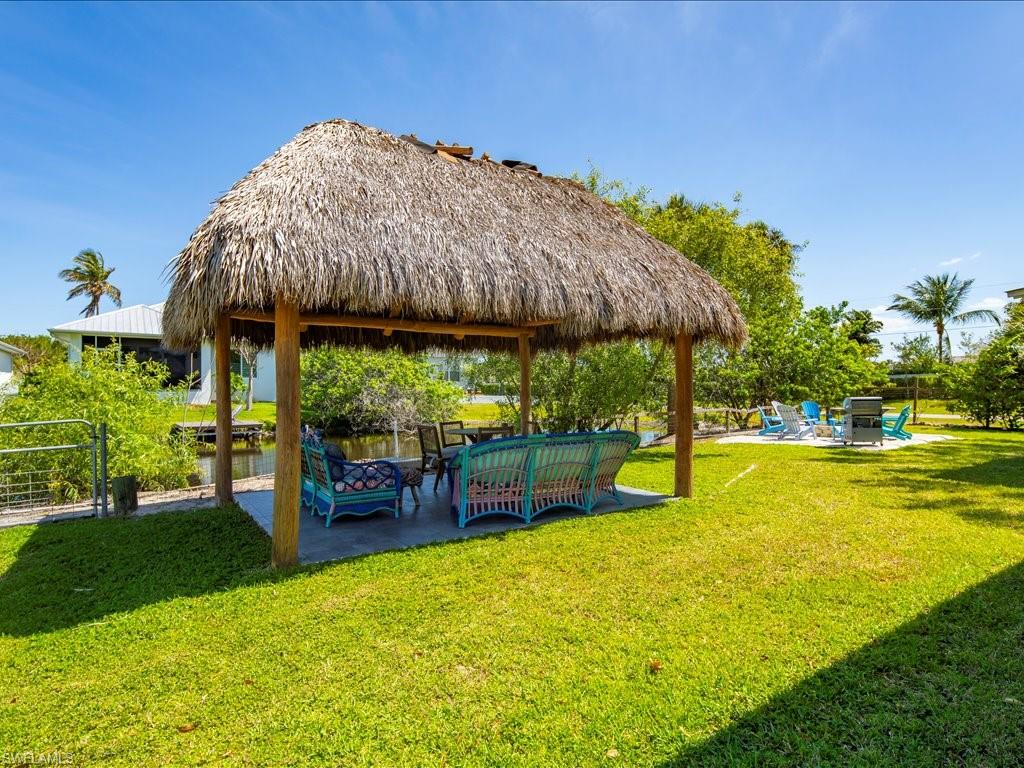 2469 Florida Avenue Naples, FL 34112 - Photo 6 of 31 View of property's community featuring a patio, a gazebo, an outdoor hangout area, and a yard