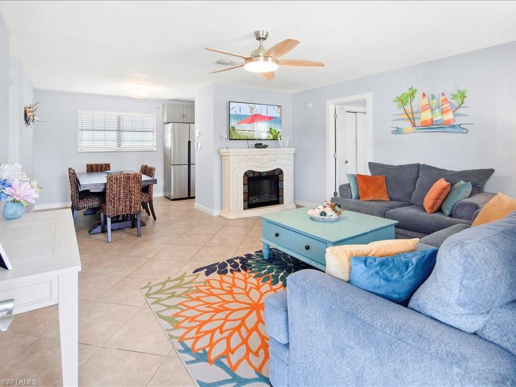 2469 Florida Avenue Naples, FL 34112 - Photo 7 of 31 Living area with light tile patterned floors, a premium fireplace, and ceiling fan